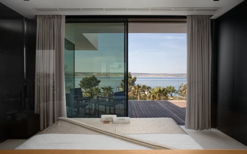 Bedroom in Villa Calma I opening onto a terrace above the sea