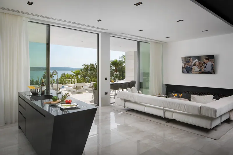 Living room with the sea through the glass wall