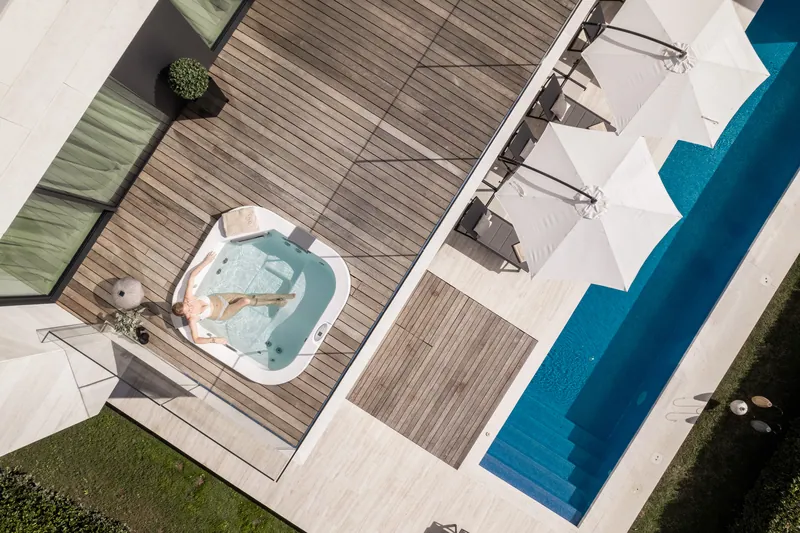 Upper deck with jacuzzi and the pool below, seen from above