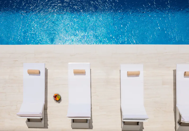 Sun loungers beside the pool, seen from above