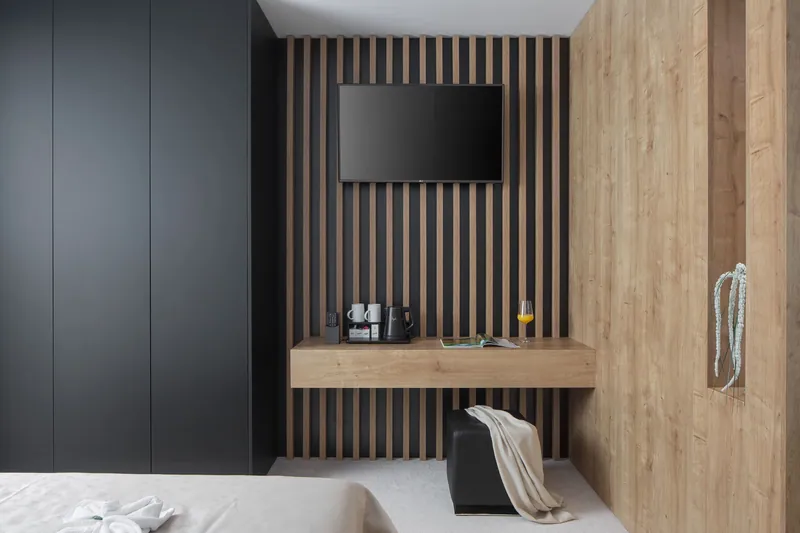 Desk and television wall in oak and black in a bedroom