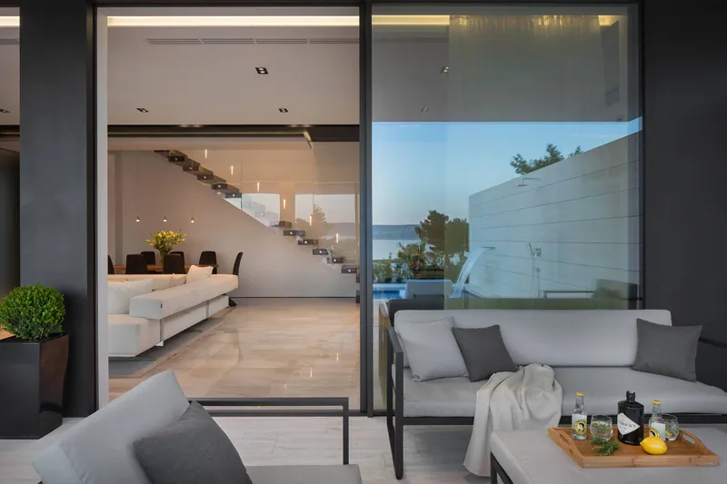 Terrace lounge at dusk, looking into the living room