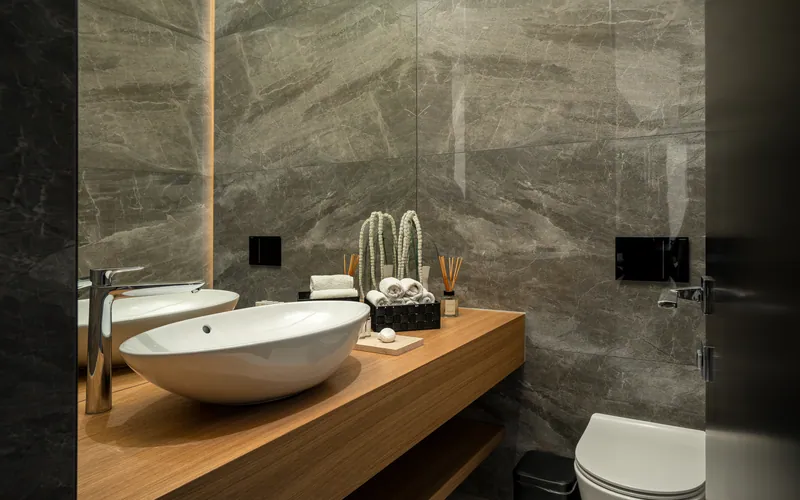 Guest toilet with stone walls and an oak counter