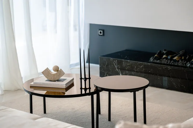 Coffee tables in the living room, with the fireplace behind