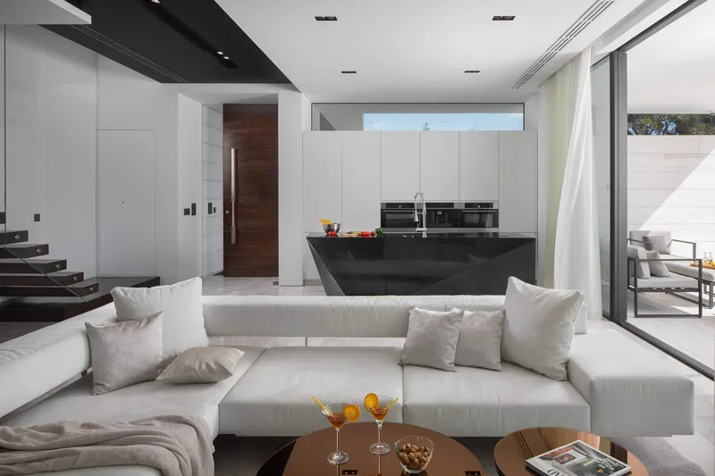 The living-room sofa with the kitchen behind