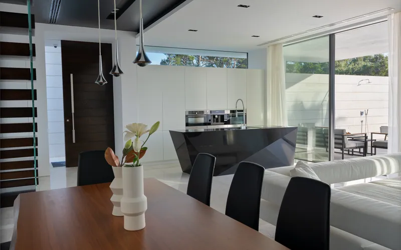 The dining table with the kitchen beyond