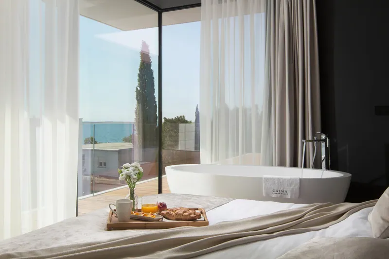 Bedroom with a freestanding bath by the window