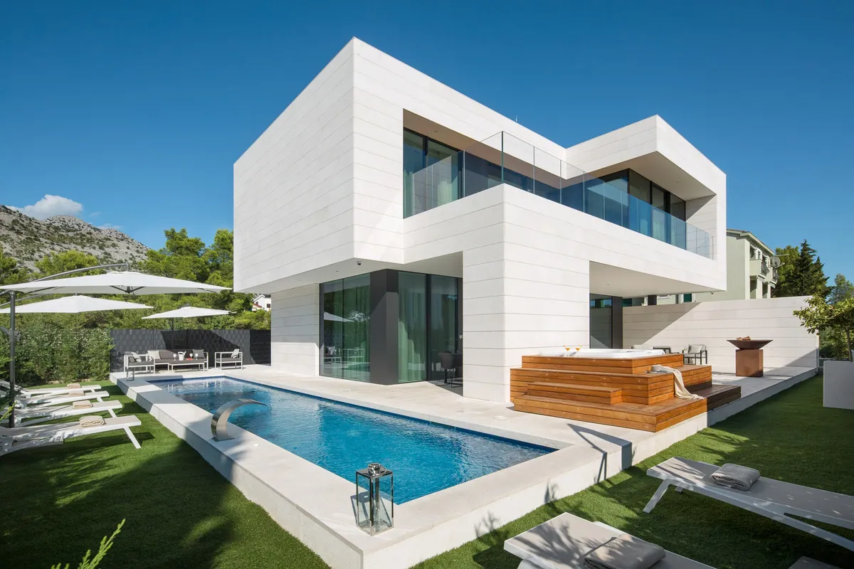 Villa Calma II seen across its heated pool, with the timber jacuzzi deck