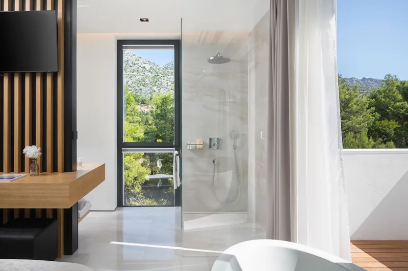 Bedroom with a walk-in shower and a window to the Velebit